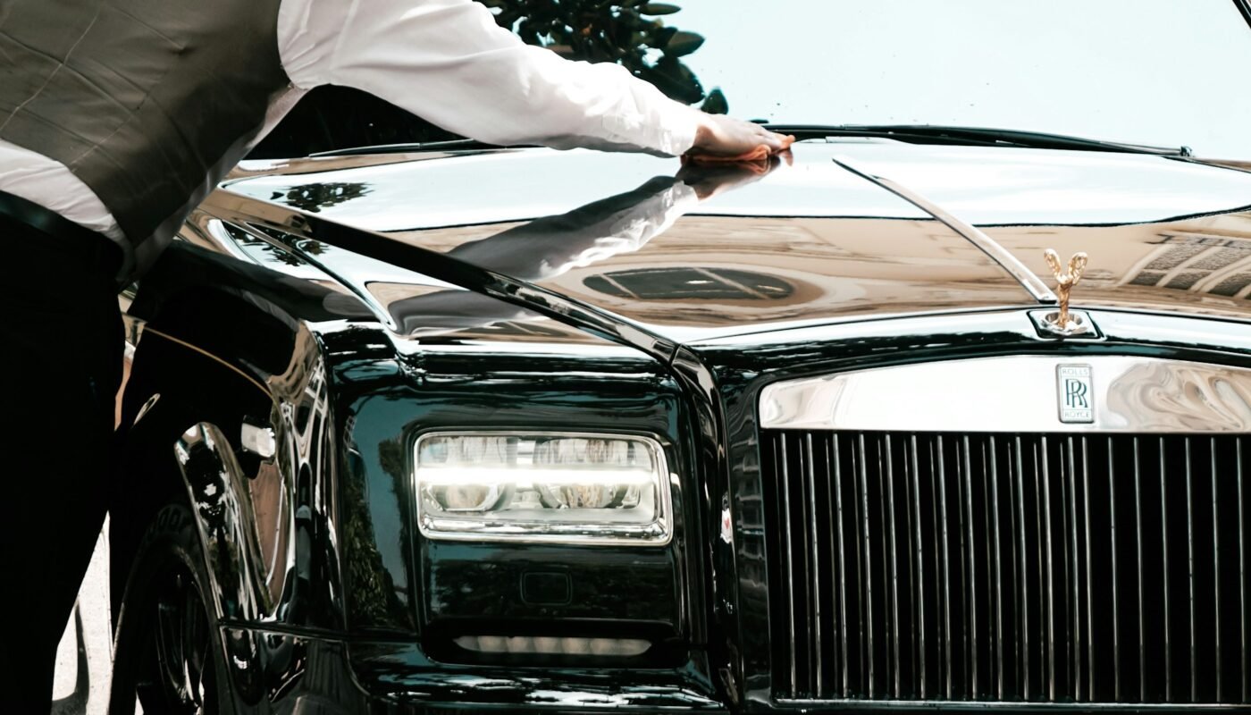 Professional chauffeur with a luxury sedan