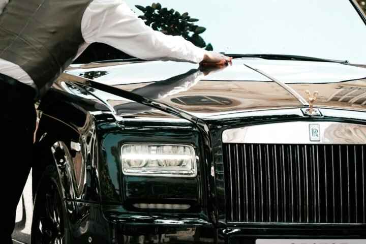 Professional chauffeur with a luxury sedan