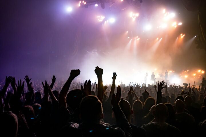 Vehicles waiting near a concert venue at night